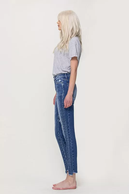 HIGH RISE ANKLE SKINNY WITH UNEVEN HEM DETAIL