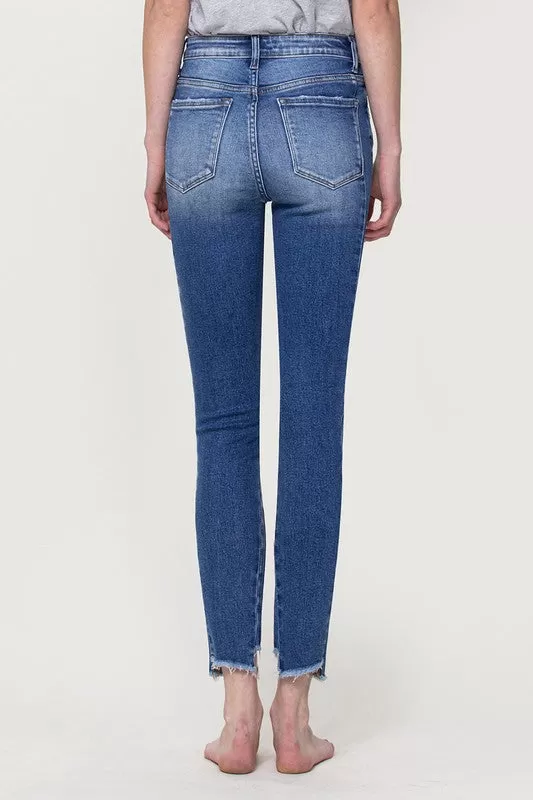 HIGH RISE ANKLE SKINNY WITH UNEVEN HEM DETAIL