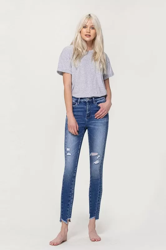 HIGH RISE ANKLE SKINNY WITH UNEVEN HEM DETAIL