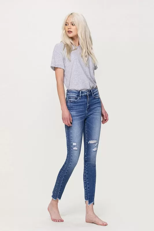 HIGH RISE ANKLE SKINNY WITH UNEVEN HEM DETAIL