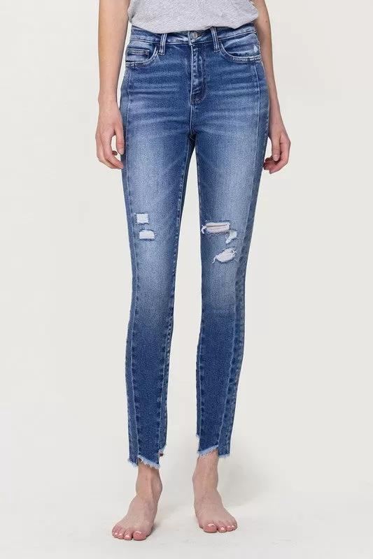 HIGH RISE ANKLE SKINNY WITH UNEVEN HEM DETAIL